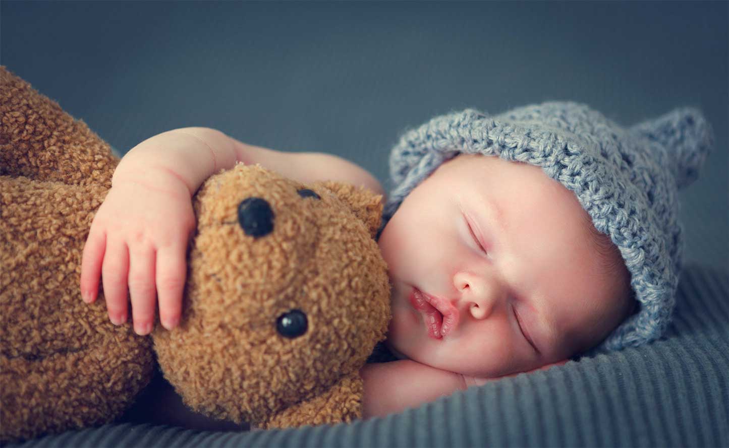 Baby Holding Teddy while Sleeping Baby Holding Teddy while Sleeping